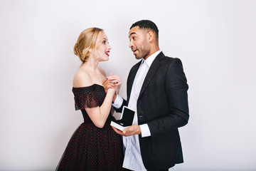 Sweet happy moments of cute couple in love on white background. Proposal of marriage, astonished, ring, present, Valentine s day, sensual, celebration together, cheerful mood, smiling