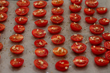 cherry tomatoes and garlic on paper for baking