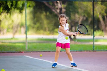 Fotobehang Child playing tennis on outdoor court © famveldman