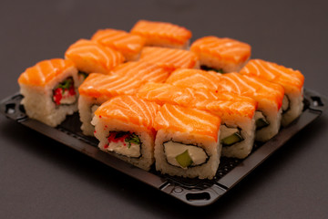 sushi in container on black background