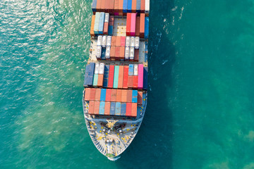 Aerial view and top view. Container ship in pier with crane bridge carries out export  and import...