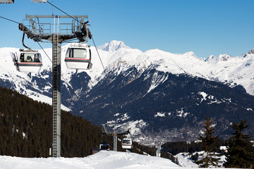 Fototapeta premium Cable car on the ski resort in France. Beautiful winter landscape and snow covered mountains