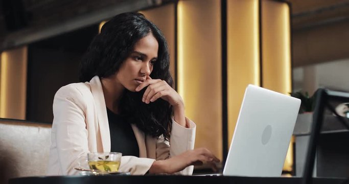 Stressed young business woman with laptop working at cafe. Hard business, people, deadline and technology concept
