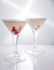 Strawberry fromage dessert in coctail glasses and lighted with artificial light. Dessert and coctail concept.