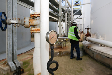 Pressure gauge at gas plant - measuring gas pressure - pipe and valve