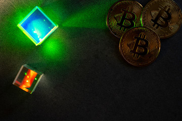 bitcoins and hexagons in the dark with Green laser glow.