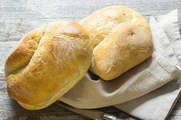 Zwei Brötchen mit Butter, Messer und Serviette, rustikal