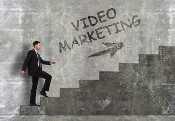 Business, technology, internet and networking concept. A young entrepreneur goes up the career ladder: Video marketing