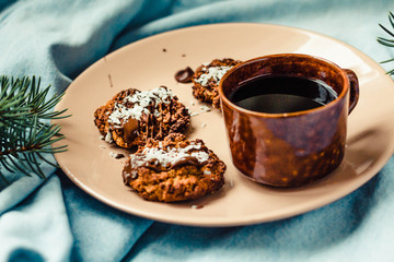 Christmas cookies with chocolate and peanuts, blue and fir-tree background