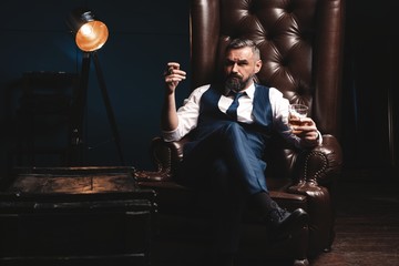 Attractive man with cigar and a glass whiskey