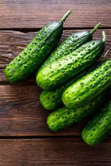 Fresh green cucumbers on wooden background. Top view