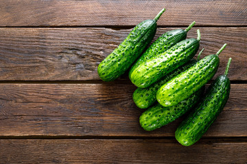 Fresh green cucumbers on wooden background. Top view