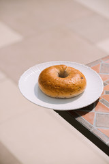 Breakfast Morning Sunny warm weather with donut on white plate on table background. Good mood Horizontal view