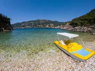 Yellow paddle boat on the beach