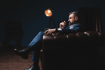 Attractive man with cigar and a glass whiskey