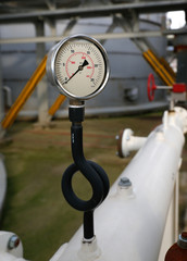 Pressure gauge at gas plant - measuring gas pressure - pipe and valve