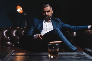 Attractive man with cigar and a glass whiskey