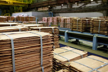 Stacks of copper sheets. Warehouse of finished products at the metallurgical plant.
