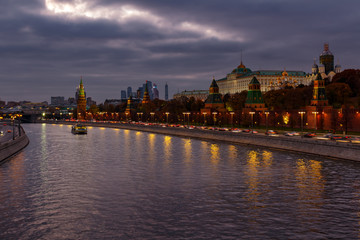 Moskva river and Moscow Kremlin on a background of dramatic cloudy sky in evening