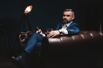 Attractive man with cigar and a glass whiskey