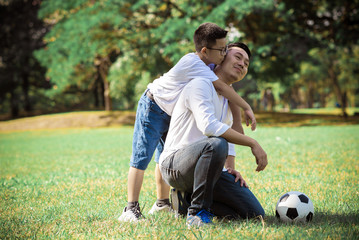 Happy children and parents playing in the park. Concept family relaxation.