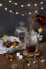  Black coffee is poured into a glass of cezve.