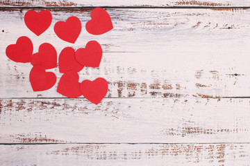 Red paper heart on wooden floor