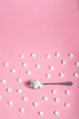 sugar sweet food. Sugar cubes - unhealthy diet concept. Cubes of sugar on pink background. Empty space for copying text. Flat lay, top view, copy space.