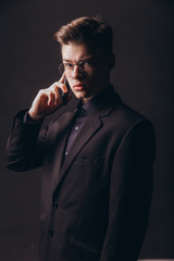 Fototapeta premium Portrait of a businessman talking on the phone - Image. Portrait of successful young man calling on cellular phone outside - Image