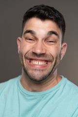 Obraz premium Handsome caucasian white male with black short hair and stubble with light blue t shirt