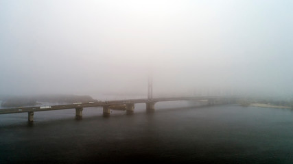 Bridge in the fog. Aerial view of South subway cable bridge. Kiev, Ukraine.