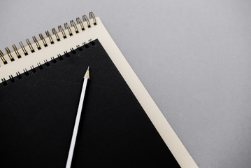 Stationary concept, Flat Lay top view Photo of notepads  on beige background with copy space.Creative flat lay photo of workspace desk with  white and black notebooks minimal style.