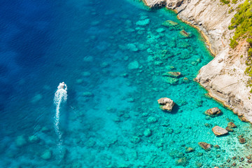 A boat going along the greek coast in summer