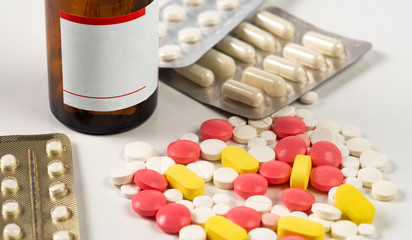 Various medicine packages and pills scattered on table