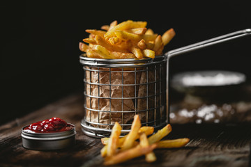 French fries in a basket with ketchup - 246185746