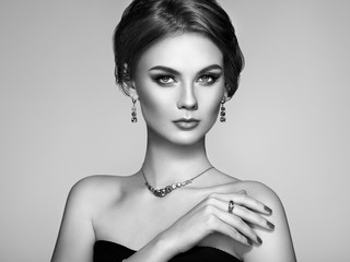 Portrait Beautiful Woman with Jewelry. Model Girl with Magnificent Manicure on Nails. Elegant Hairstyle. Fashion Make-up Arrows. Beauty and Accessories