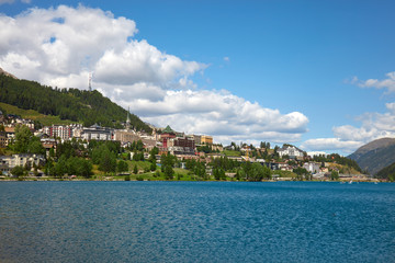 Fototapeta premium Sankt Moritz town and lake in a sunny summer day, white clouds in Switzerland