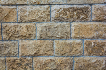 Brick wall textured background in yellow tones texture