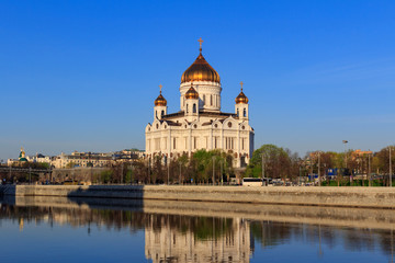 Fototapeta na wymiar Cathedral of Christ the Saviour in Moscow on a background of Prechistenskaya Embankment of Moskva river at sunny spring morning