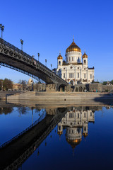 Fototapeta na wymiar Cathedral of Christ the Saviour and Patriarshiy Bridge with reflection on water surface of Moskva river at sunny spring morning