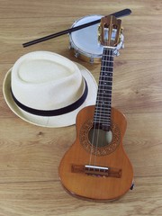 Naklejka premium A samba player (sambista) hat and two Brazilian musical instruments: cavaquinho and tamborim with drumstick. The instruments are widely used to accompany samba, a popular Brazilian rhythm.