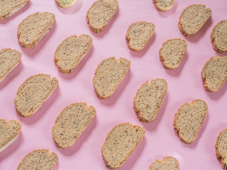 Bread with seeds pattern on pink background