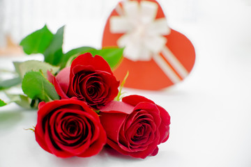 Flowers composition with gift box heart shaped  made of rose flowers on white background. Flat lay, top view, copy space