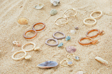 Handmade Jewelry on Sand Beach Top Down View. Travel Cheap Jewels Souvenir on Sea Shell Background. Craft Summer Earring and Stone Ring for Fashion Gift. Aquamarine Beautiful Decoration Set