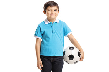 Smiling young boy holding a soccer ball