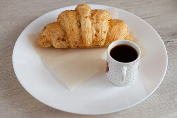 cup of coffee and cake on wooden table
