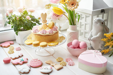 Fototapeta na wymiar Easter composition with sweet bread, Easter cake, eggs, bouquet of flowers. Holidays breakfast concept with copy space. Traditional easter cake with gingerbread cookies. Easter Greeting Card Template