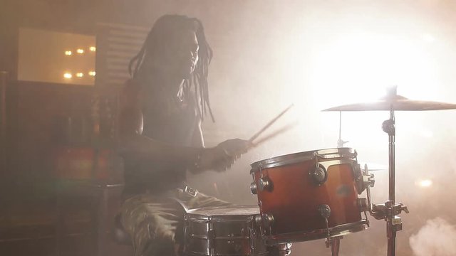 Talented drummer performing at night club.