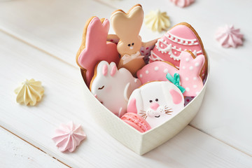 Closeup of colorful easter cookies on white background. Easter Postcard Template. Cookies in shape of eggs and Easter bunny. Happy Easter holiday background concept.Sweets for celebrate 