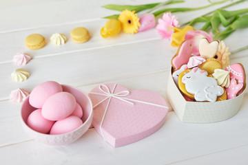 Easter greeting card with flowers, gingerbread cookies and eggs. Easter Postcard Template. Cookies in shape of eggs and Easter bunny. Happy Easter holiday background concept.